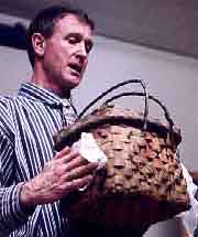 Dr. Handsman holding a 1830s painted Nipmuc storage basket