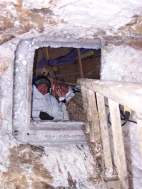 Ernest Nageak and his father Roy Nageak waiting to pull up dirty snow